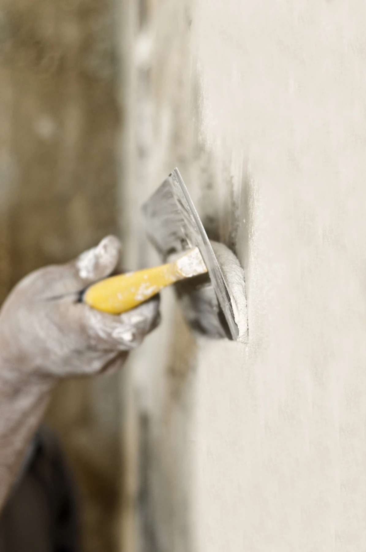 A craftsperson hand-finishing a gypsum plaster surface